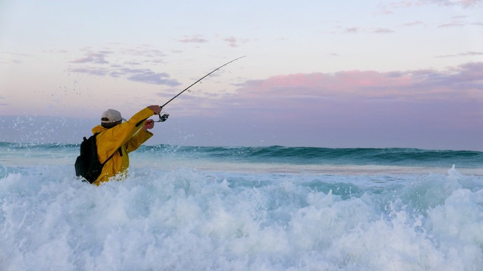fisherman in the ocean foam wave