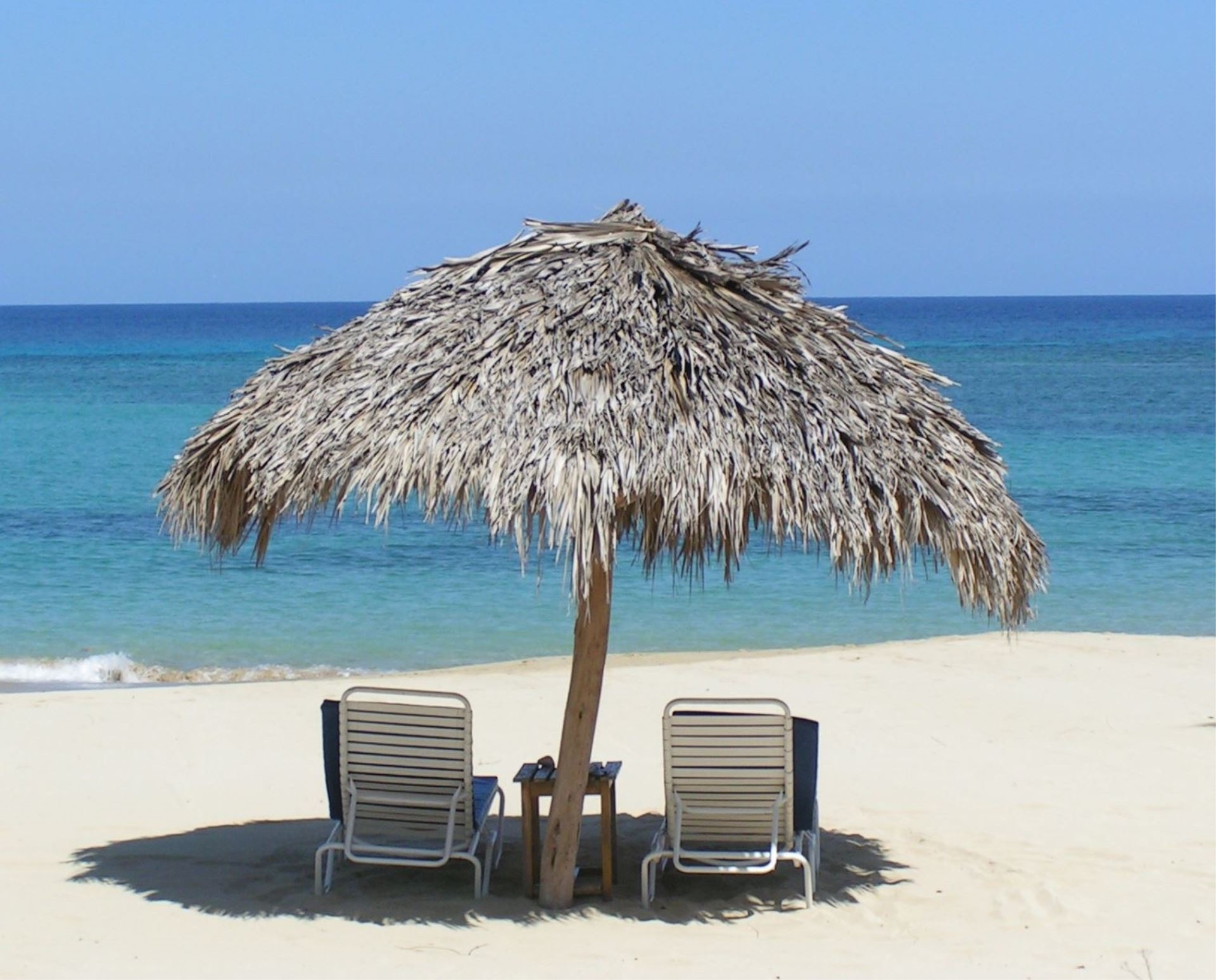 Tropical Paradise Beach Chairs Beneath Parasol In Front Of Sea Free Image Download