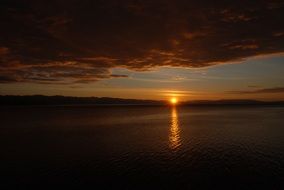 distant view of a bright sunset over the water