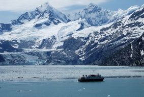 cruise ship is sailing along glaciers in alaska