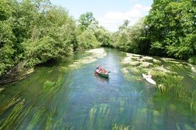 Canoeing on Tauber river at summer, germany
