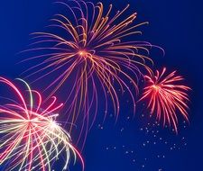 pink fireworks in the evening sky
