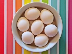 eggs in a bowl on a colorful tablecloth