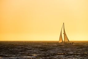 Sailing Boat on ocean at the sunset