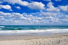 Blue Sky with fluffy Clouds above sea