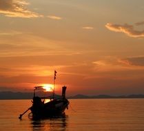 boat on the background of a romantic sunset