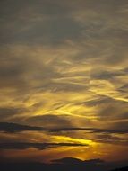 gray clouds and the golden glow of the sun