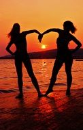 silhouettes of girlfriends at bright sunset