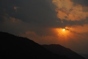 sunset in the clouds over the mountains