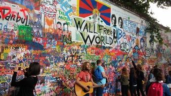 street musicians on the background of John Lennon Wall