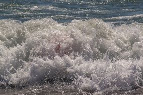 splashing from the waves in the bright sun