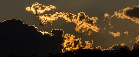 the glow of the sun from behind the clouds