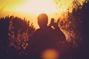 Photographer make a photo of sunset