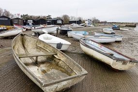 many wooden fishing boats on waterside