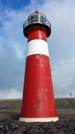 red lighthouse on the cape close up