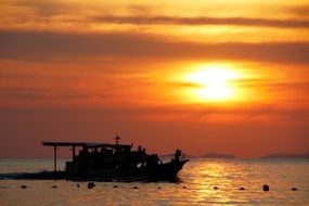 silhouette of a boat at sunset in thailand
