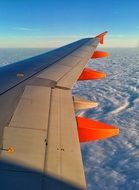 orange lights on the wing of an airplane