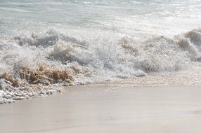foam water on a sandy beach on cape verde
