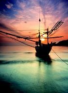 silhouette of fishing boat at sunset