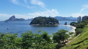 scenic green coastline and distant blue rocks in sea, brazil, Rio De Janeiro