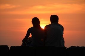 couple in the rays of a bright sunset