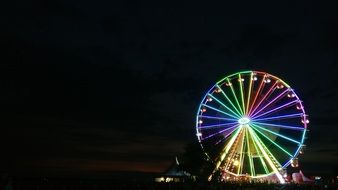 The Ferris wheel glows with bright lights