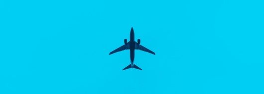 airplane in the sky on a turquoise background