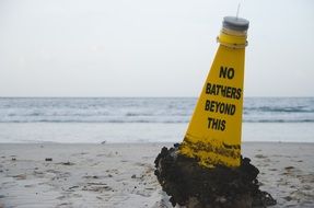 yellow buoy on a sandy beach