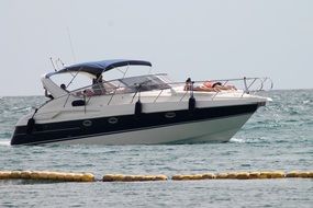 tourists sunbathe on the bow of a motor boat at sea