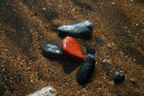 red and black pebbles on brown sand, spain, canary, Tenerife