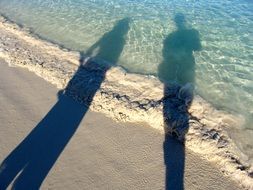 shadows of people on the beach