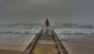 man on the pier in a mystical landscape