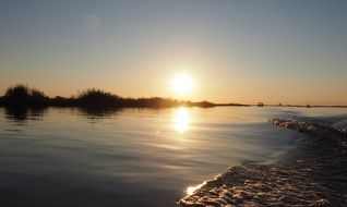 sun on the horizon above the water