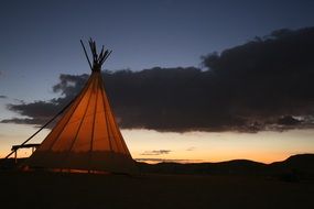 Tent on a hill at the sunset time