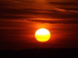 hot yellow evening sun in the dark sky