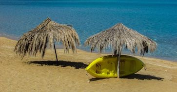 scenic umbrellas and yellow canoes on the beach