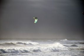 black and white photo of windsurfing on the ocean