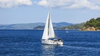 panoramic view of a snow-white yacht off the coast of greece