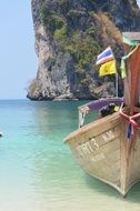 wooden boat on the blue water of the ocean