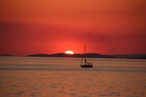 panoramic view of a sailing boat against the backdrop of a romantic sunset
