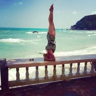 Girl doing Yoga Pose on a coast