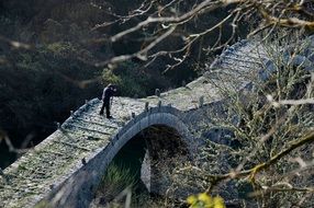 photographer on the ancient stone bridge