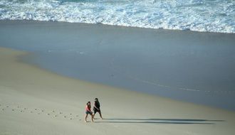 Walking humans on a beach