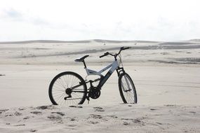 white sports bike on a sandy beach