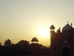 silhouette of a Taj Mahal at bright sunset