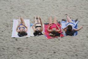 Women are lying on the beach in France