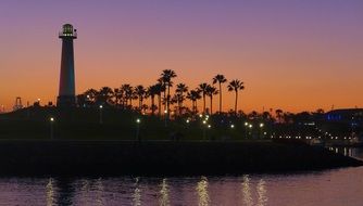 Lighthouse on tropical island at dusk