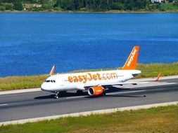 plane on the runway near the lake