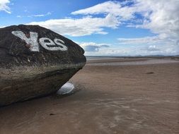 Yes sign on a rock