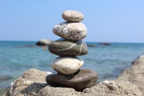 stone pyramid on the summer beach